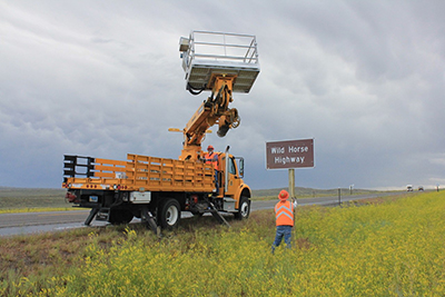 Flores-Stanger-installing-Sign.jpg